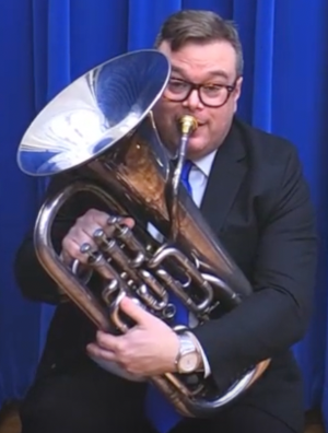 Resting the euphonium on your lap and bending over it